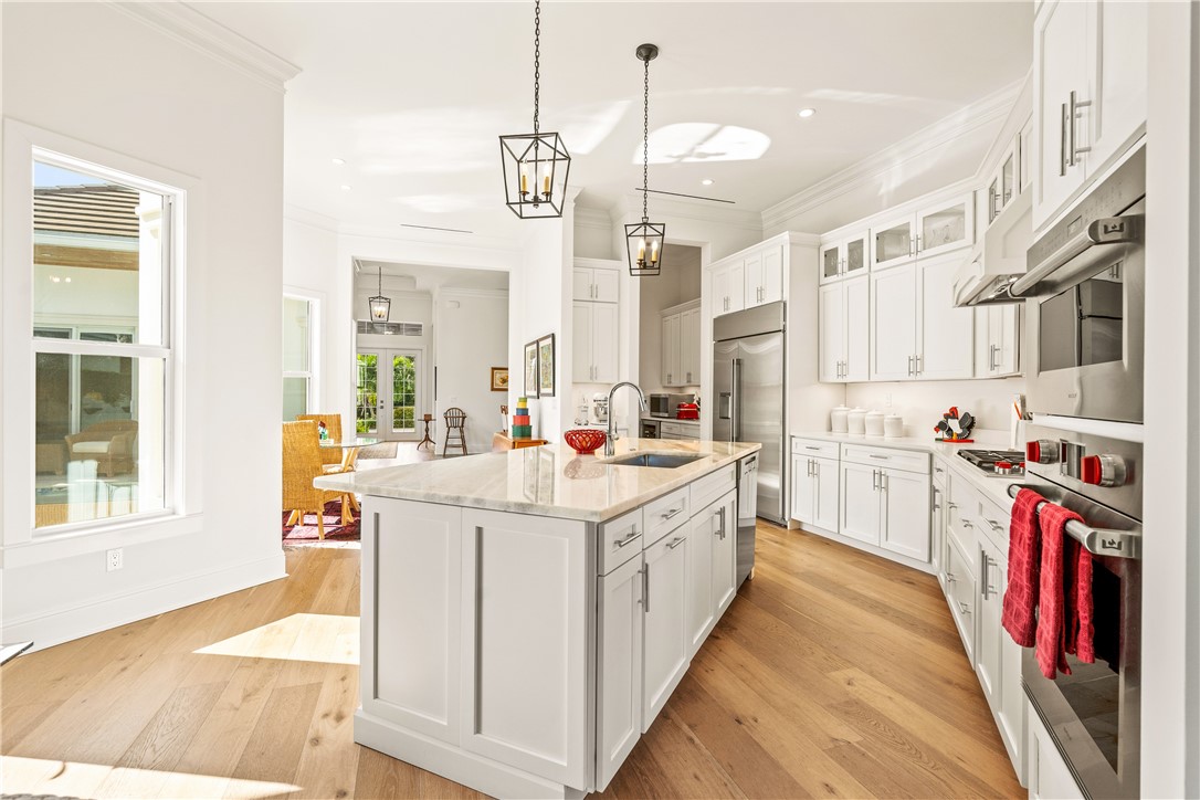 11 Caribe Way Vero Beach, FL 32963 - Photo 13 of 34 a kitchen that has a lot of cabinets in it and wooden floors