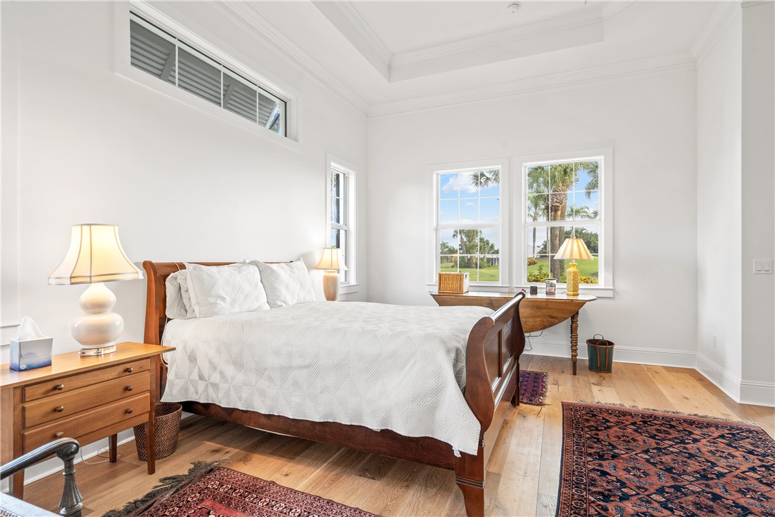 11 Caribe Way Vero Beach, FL 32963 - Photo 17 of 34 a bedroom with a bed and a window with lamp