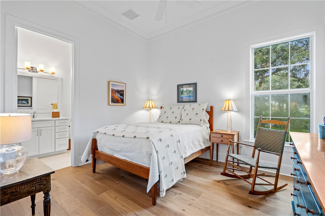 11 Caribe Way Vero Beach, FL 32963 - Photo 20 of 34 a bedroom with a bed a chair and a large window
