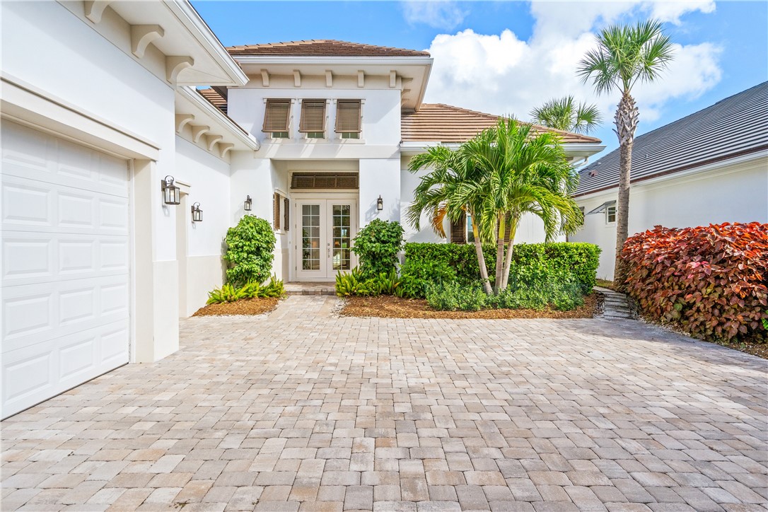 11 Caribe Way Vero Beach, FL 32963 - Photo 2 of 34 a front view of a house with garden