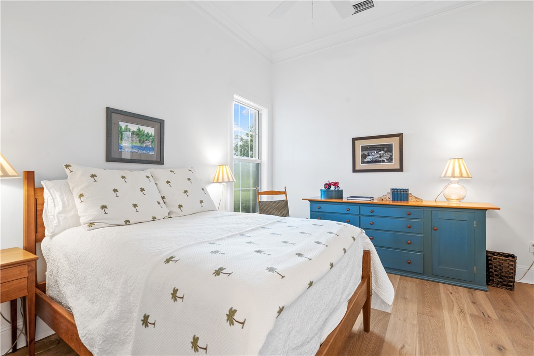 11 Caribe Way Vero Beach, FL 32963 - Photo 21 of 34 a bedroom with a bed and a dresser