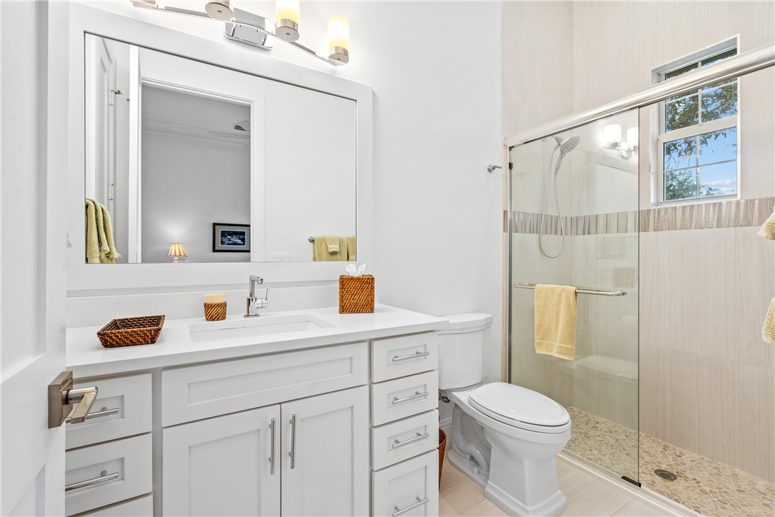 11 Caribe Way Vero Beach, FL 32963 - Photo 22 of 34 a bathroom with a sink a toilet and shower