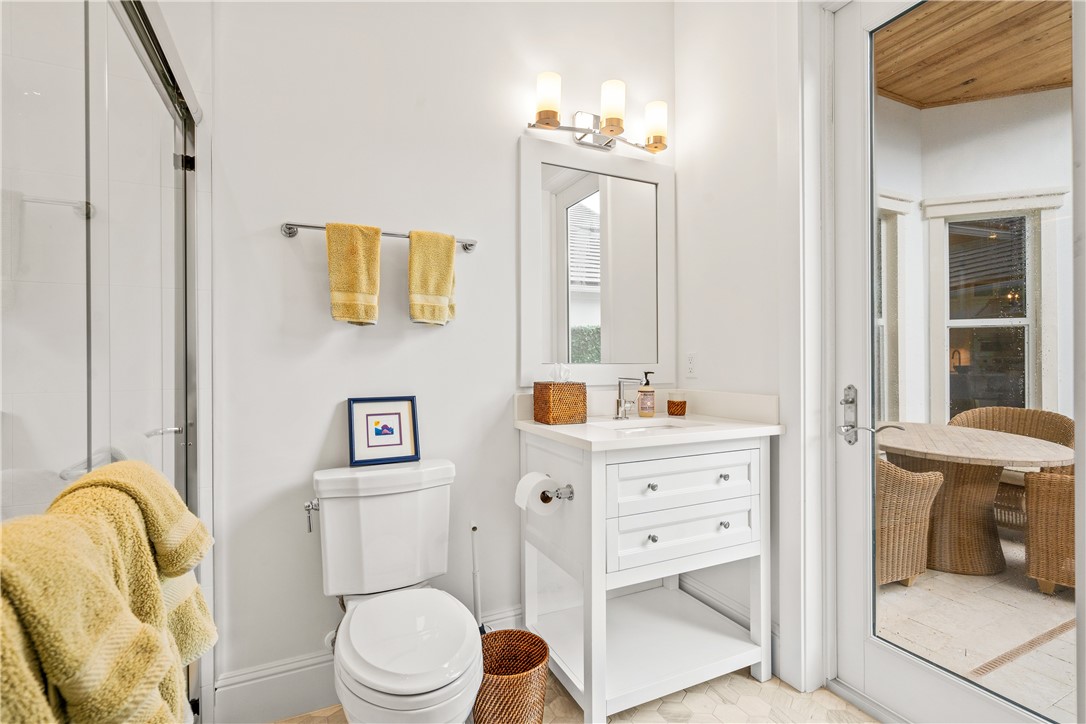 11 Caribe Way Vero Beach, FL 32963 - Photo 24 of 34 a bathroom with a sink a toilet and a mirror