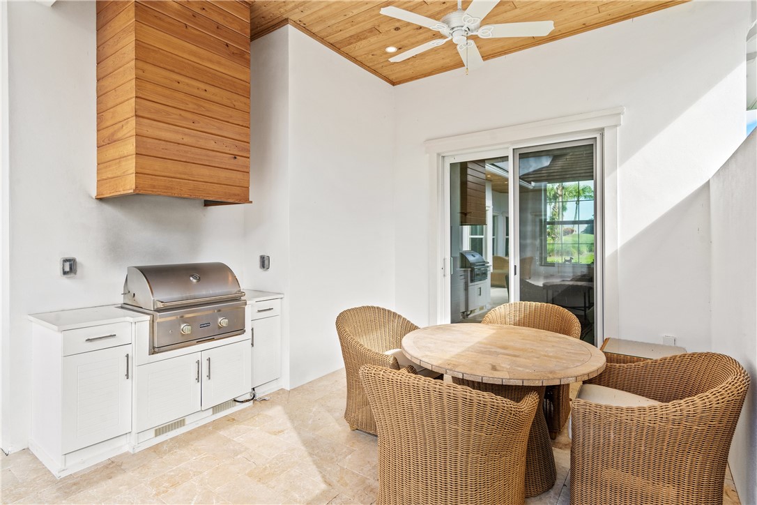 11 Caribe Way Vero Beach, FL 32963 - Photo 27 of 34 a kitchen with stainless steel appliances granite countertop a stove a sink and a cabinets