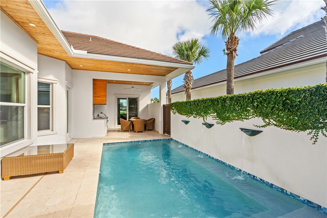 11 Caribe Way Vero Beach, FL 32963 - Photo 29 of 34 a view of a house with a swimming pool and a porch