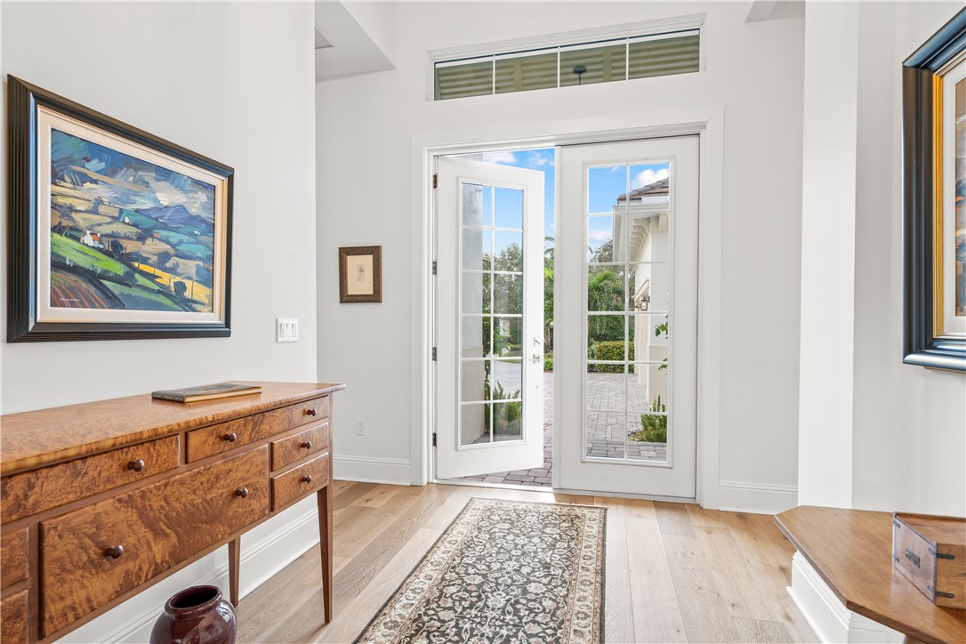 11 Caribe Way Vero Beach, FL 32963 - Photo 5 of 34 a view of a bedroom with wooden floor and windows