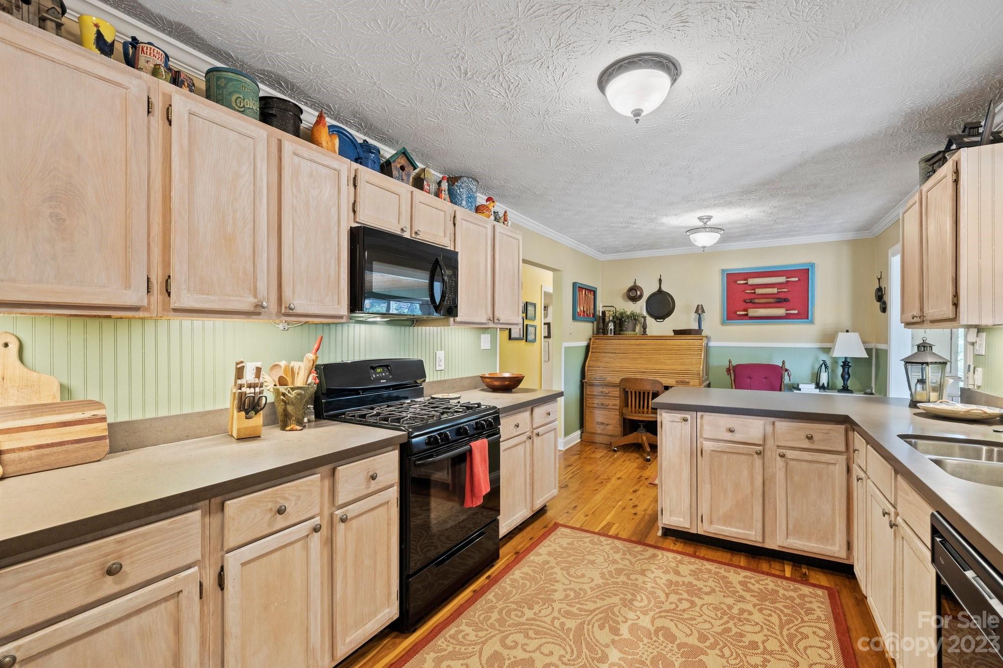 7 Quail Pointe Fletcher, NC 28732 - Photo 12 of 36 a kitchen with stainless steel appliances granite countertop a stove sink and cabinets