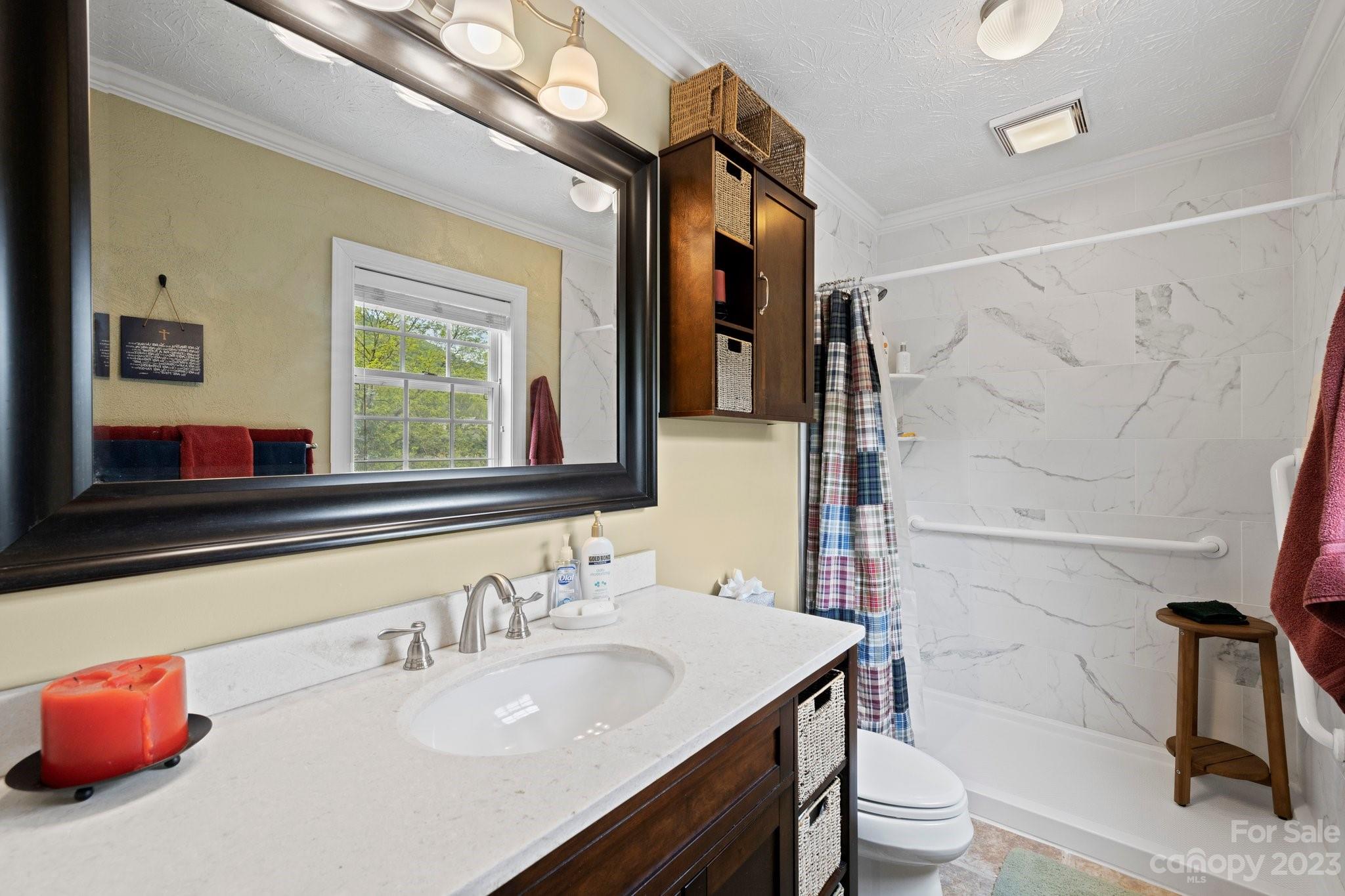 7 Quail Pointe Fletcher, NC 28732 - Photo 17 of 36 a bathroom with a granite countertop sink and a mirror