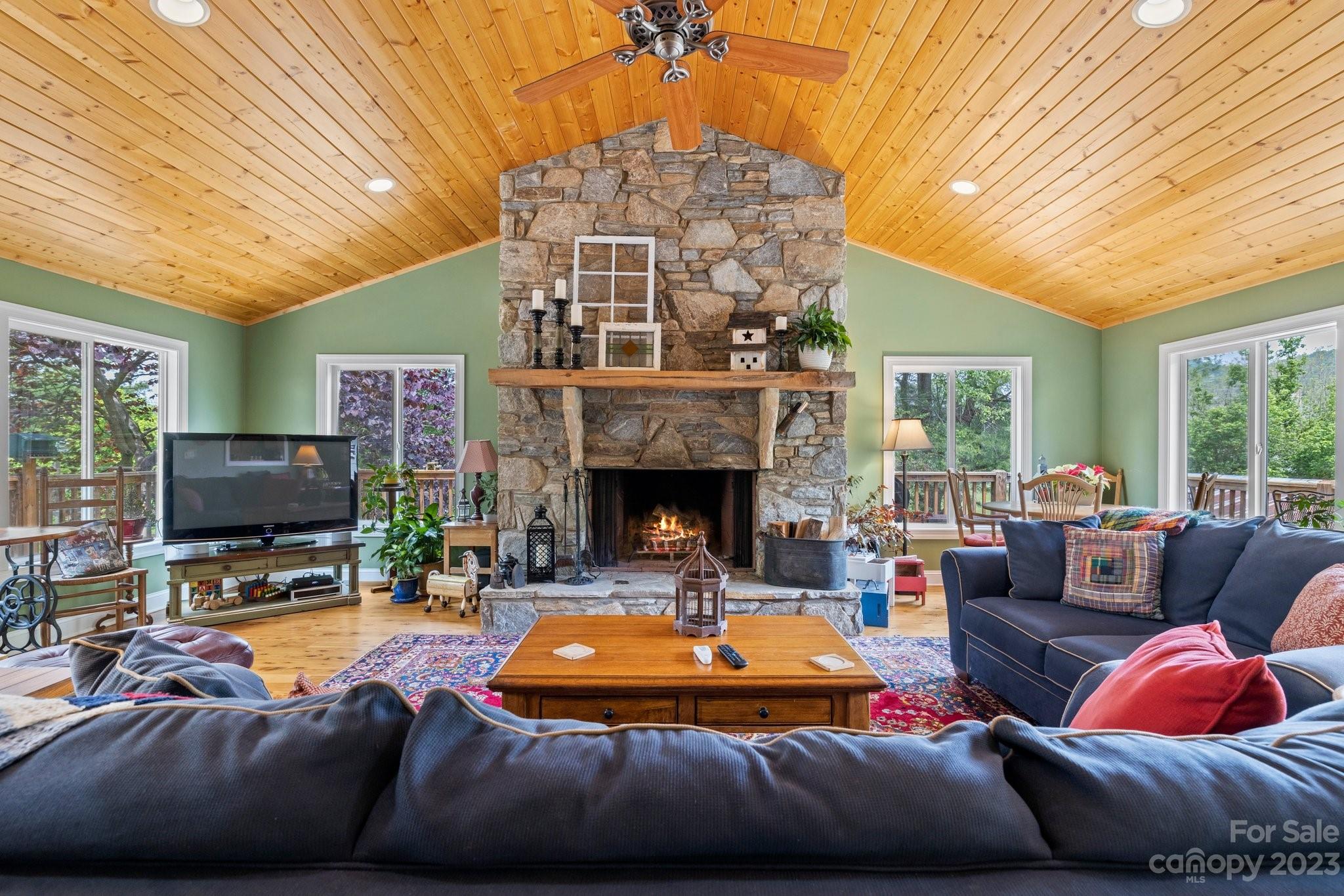 7 Quail Pointe Fletcher, NC 28732 - Photo 3 of 36 a living room with furniture a fireplace and a flat screen tv