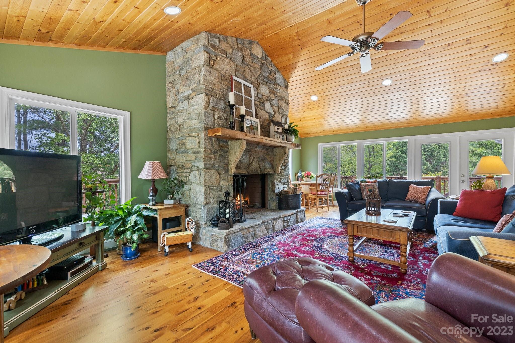 7 Quail Pointe Fletcher, NC 28732 - Photo 6 of 36 a living room with furniture a flat screen tv and a fireplace