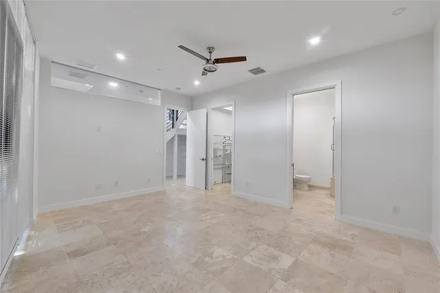 a view of a livingroom with a ceiling fan and window