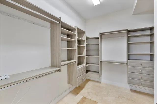 a spacious bathroom with a shower sink and mirror