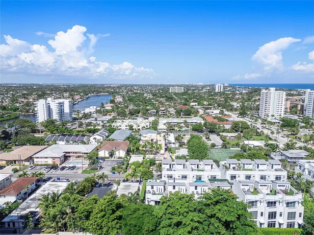 a view of a white house next to a yard