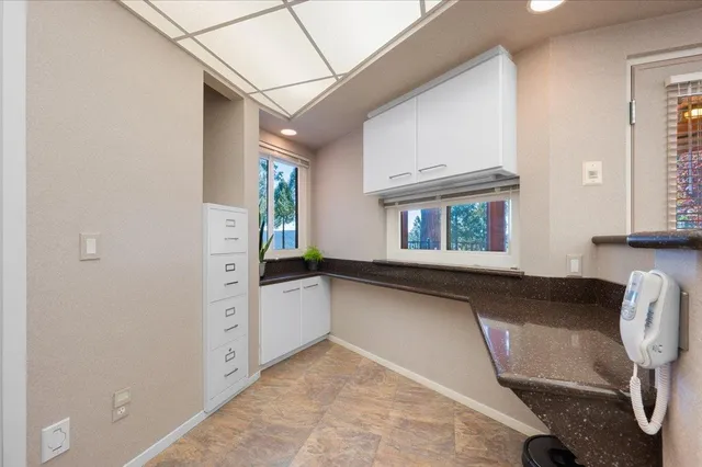 a room with a bed and a large window