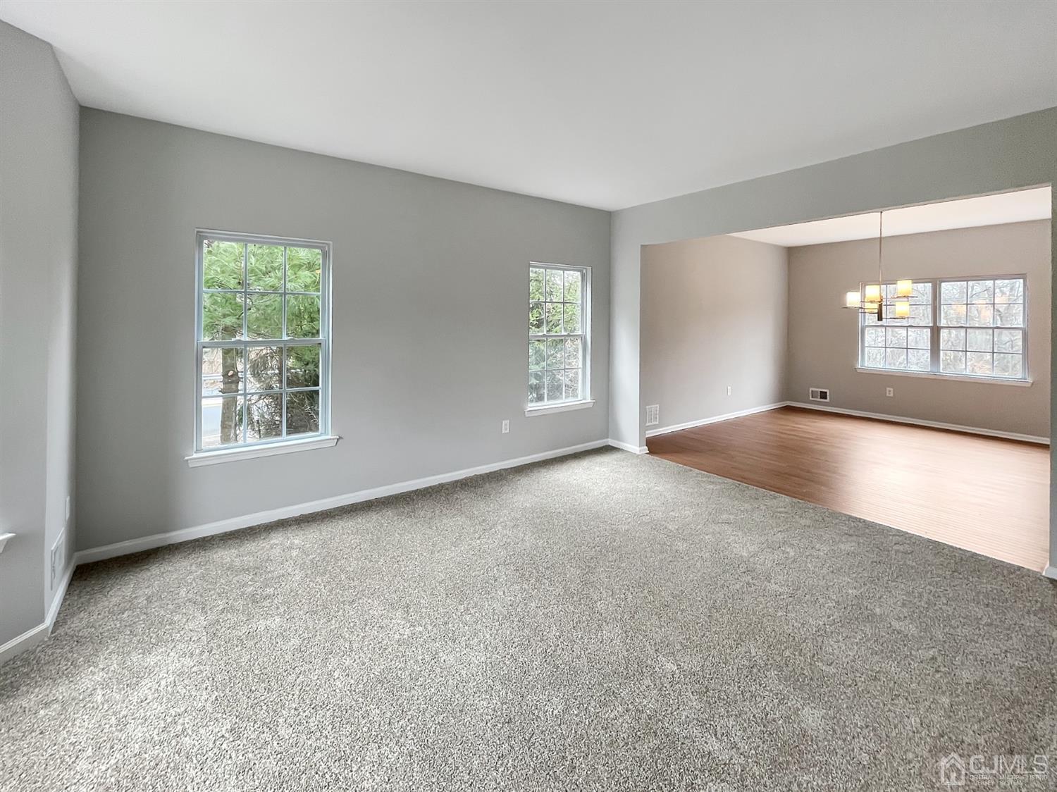 1 Cannon Road Old Bridge, NJ 08857 - Photo 11 of 23 a view of a big room with windows and chandelier fan
