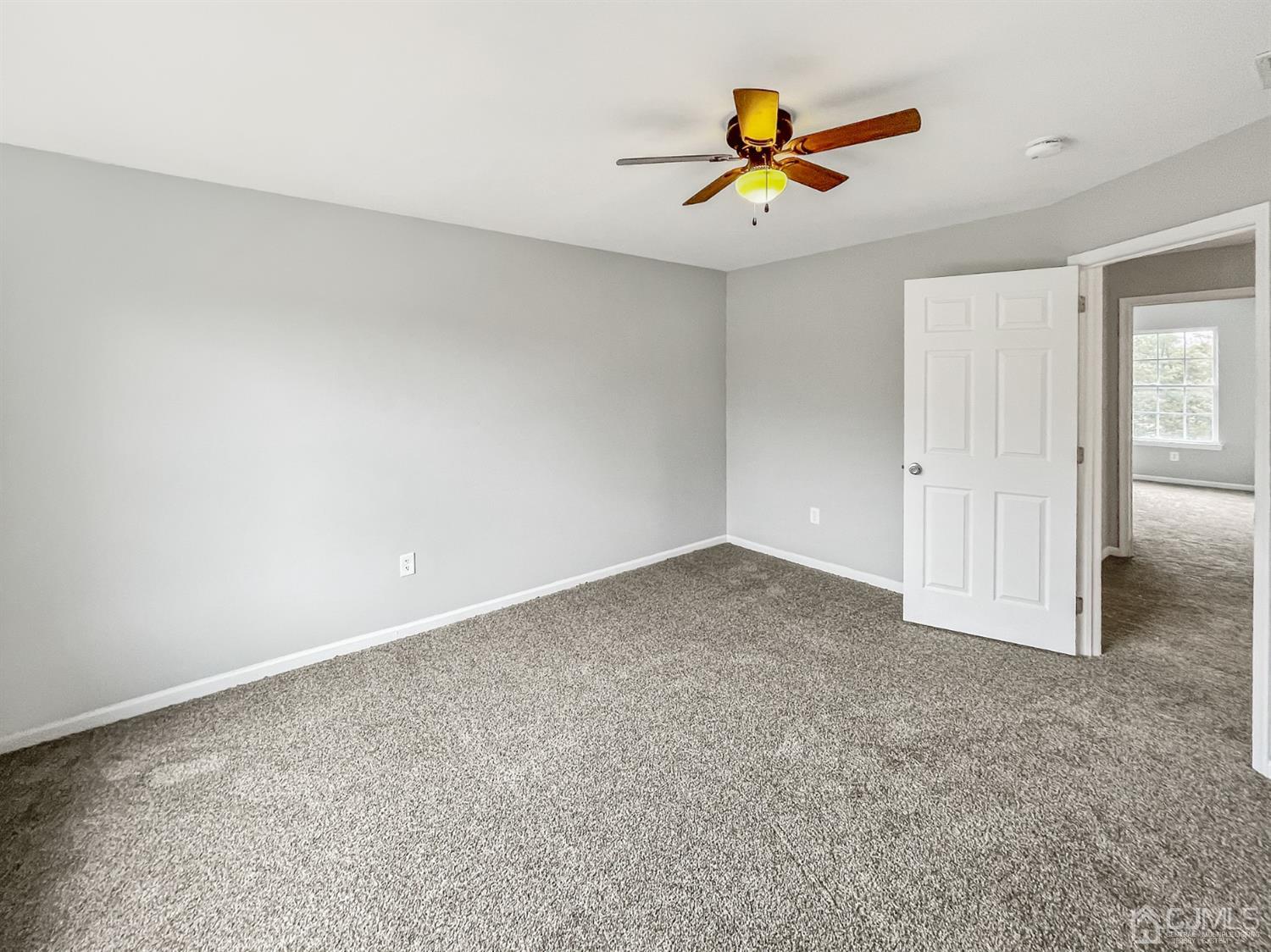 1 Cannon Road Old Bridge, NJ 08857 - Photo 15 of 23 an empty room with closet and a ceiling fan