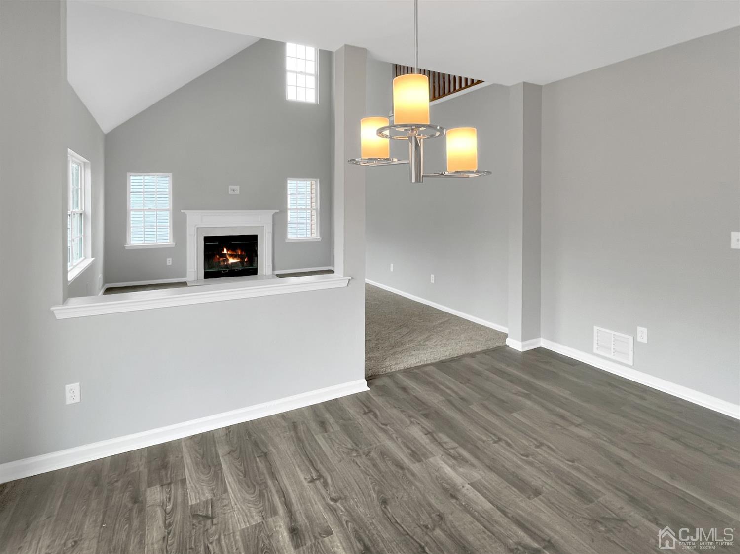 1 Cannon Road Old Bridge, NJ 08857 - Photo 7 of 23 an empty room with wooden floor and fireplace