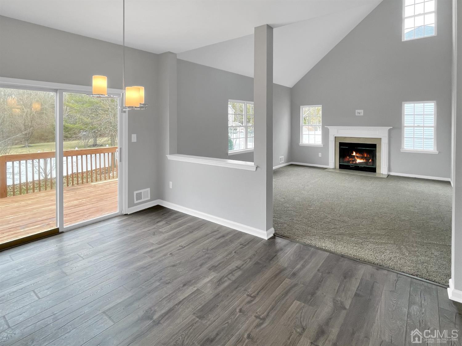 1 Cannon Road Old Bridge, NJ 08857 - Photo 8 of 23 an empty room with wooden floor and fireplace