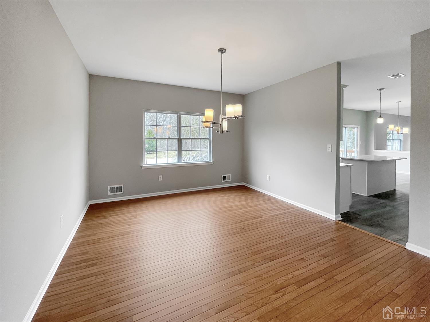 1 Cannon Road Old Bridge, NJ 08857 - Photo 9 of 23 an empty room with wooden floor and windows