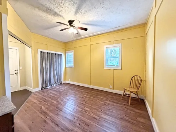 a room with a wooden floor and mirror