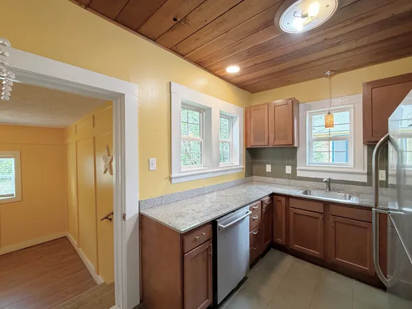 a kitchen with a sink stove and cabinets