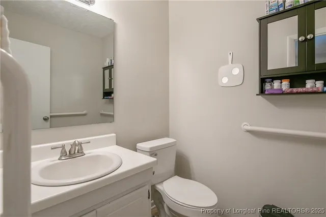 a bathroom with a toilet a sink and a mirror
