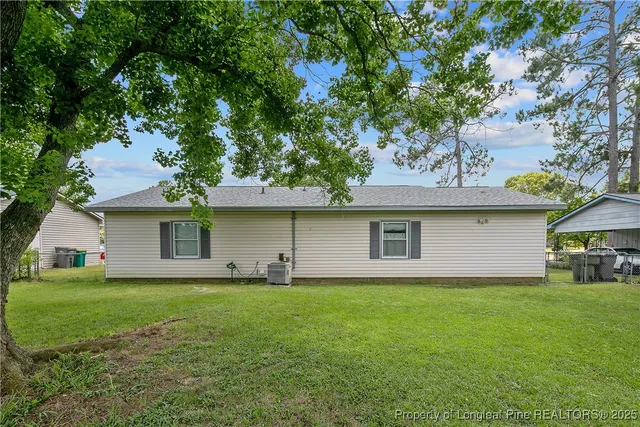 a front view of house with yard and trees
