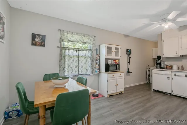 a living room with furniture a flat screen tv and a window