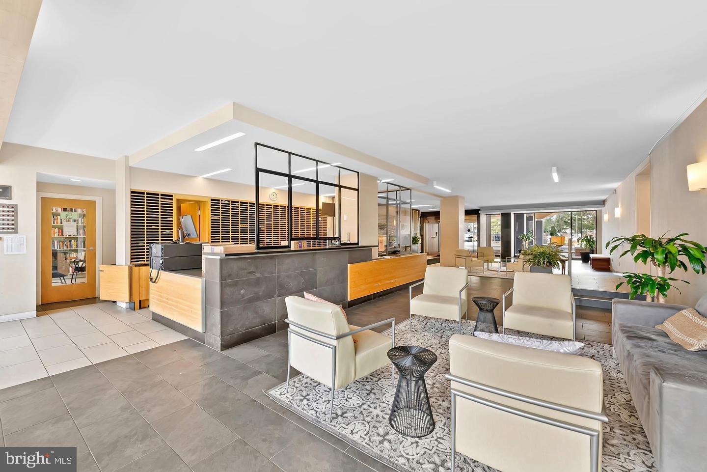 2939 Van Ness Street Northwest, Unit 845 Washington, DC 20008 - Photo 16 of 22 a living room with furniture and a view of kitchen