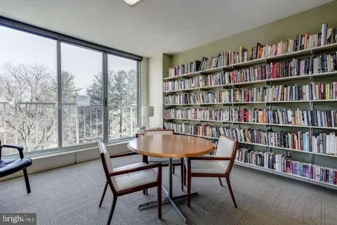 a reading room with furniture and a book shelf
