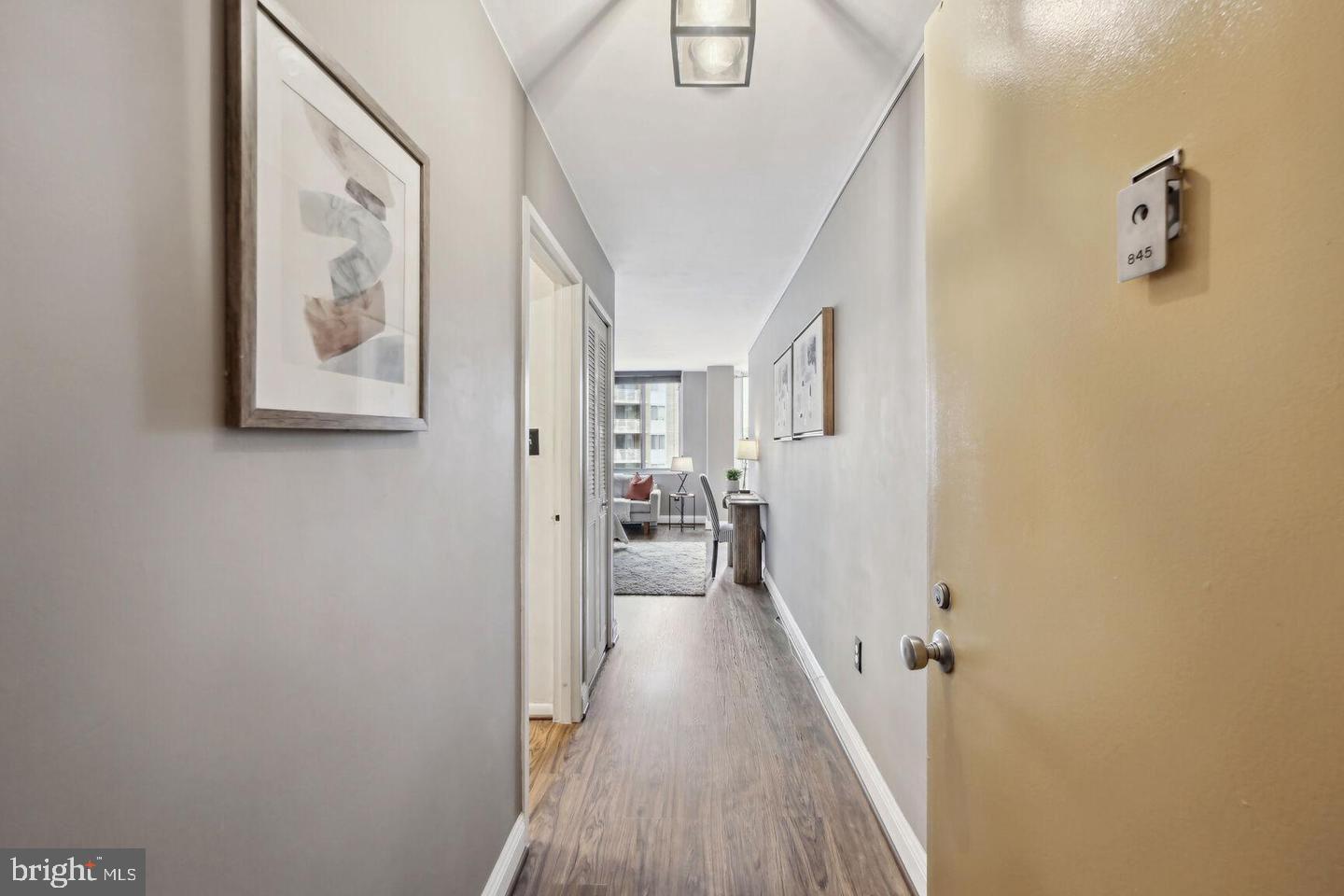 2939 Van Ness Street Northwest, Unit 845 Washington, DC 20008 - Photo 2 of 22 a view of a hallway with wooden floor and staircase