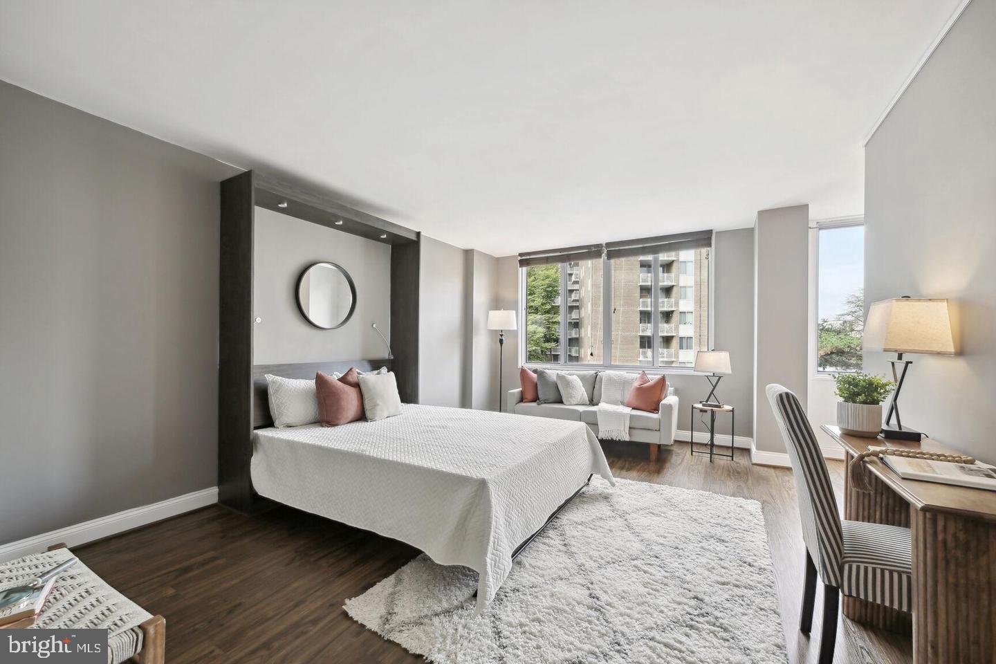 2939 Van Ness Street Northwest, Unit 845 Washington, DC 20008 - Photo 3 of 22 a bedroom with a bed and wooden floor
