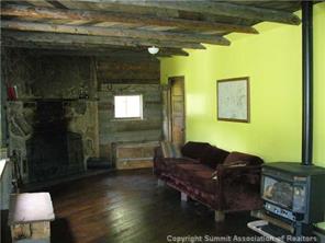 8353 Pcr 18 Road Fruita, CO 81521 - Photo 6 of 11 a living room with a table chairs and a fireplace