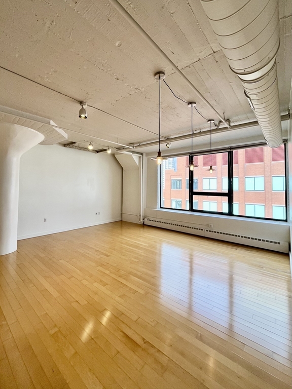 210 South Street, Unit 113 Boston, MA 02111 - Photo 1 of 17 a view of an empty room with a window