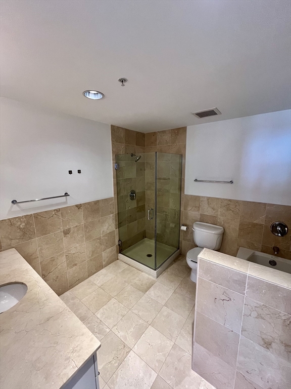 210 South Street, Unit 113 Boston, MA 02111 - Photo 14 of 17 a bathroom with a tub shower and sink