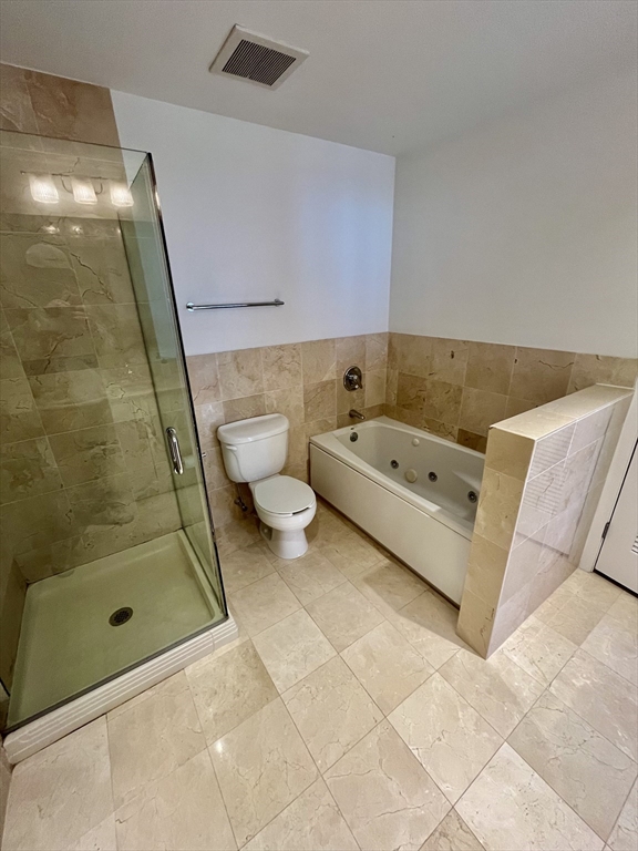 210 South Street, Unit 113 Boston, MA 02111 - Photo 15 of 17 a bathroom with a tub and a shower