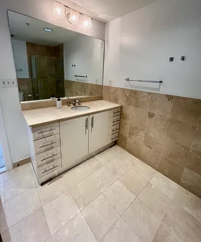 a bathroom with a sink a vanity and a mirror