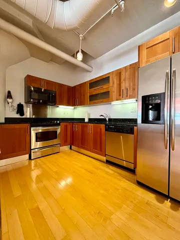 a kitchen with stainless steel appliances granite countertop a sink and cabinets