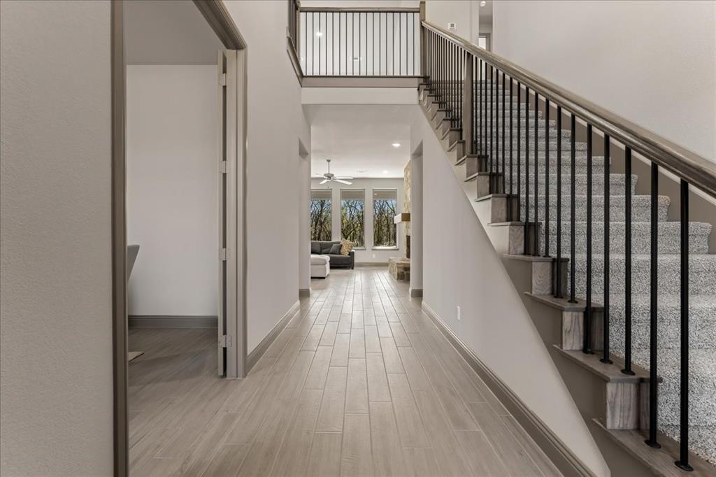 131 Spring Valley Road Paradise, TX 76073 - Photo 3 of 40 a view of a hallway with wooden floor and stairs
