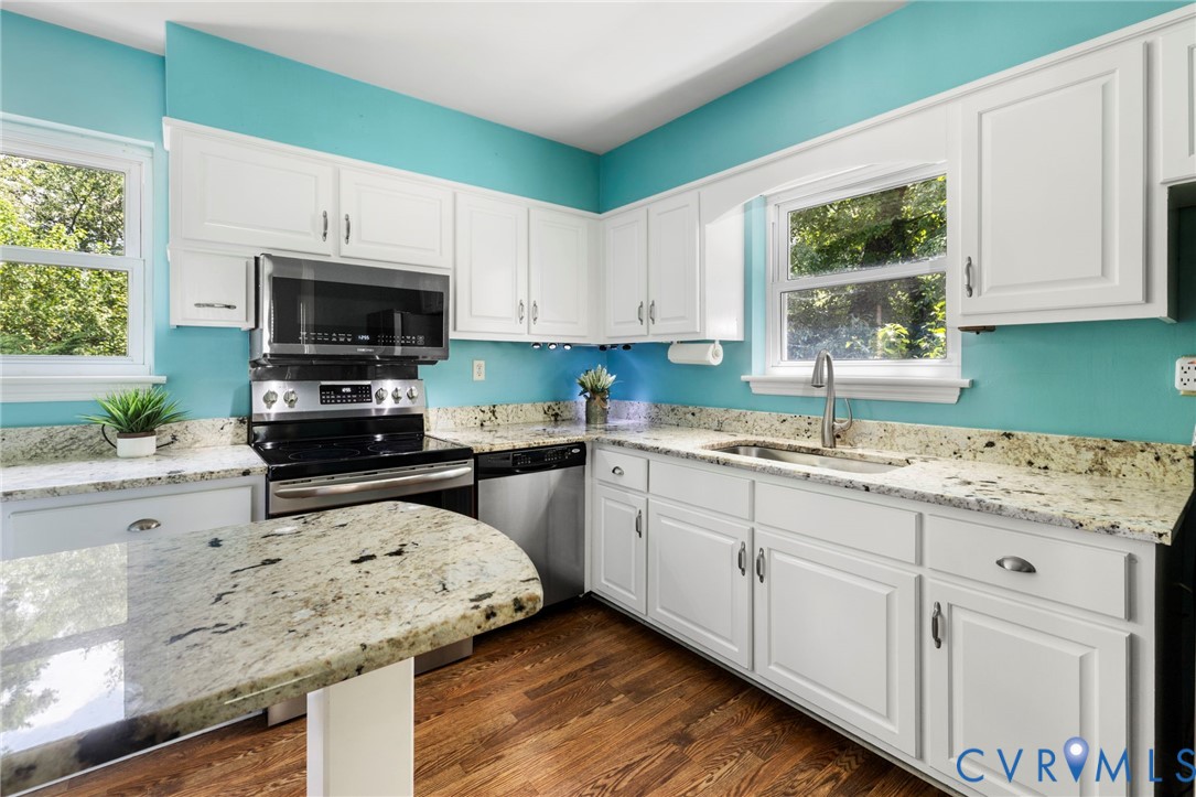 7644 Cherokee Road Richmond, VA 23225 - Photo 11 of 31 Kitchen with stainless steel appliances, dark wood