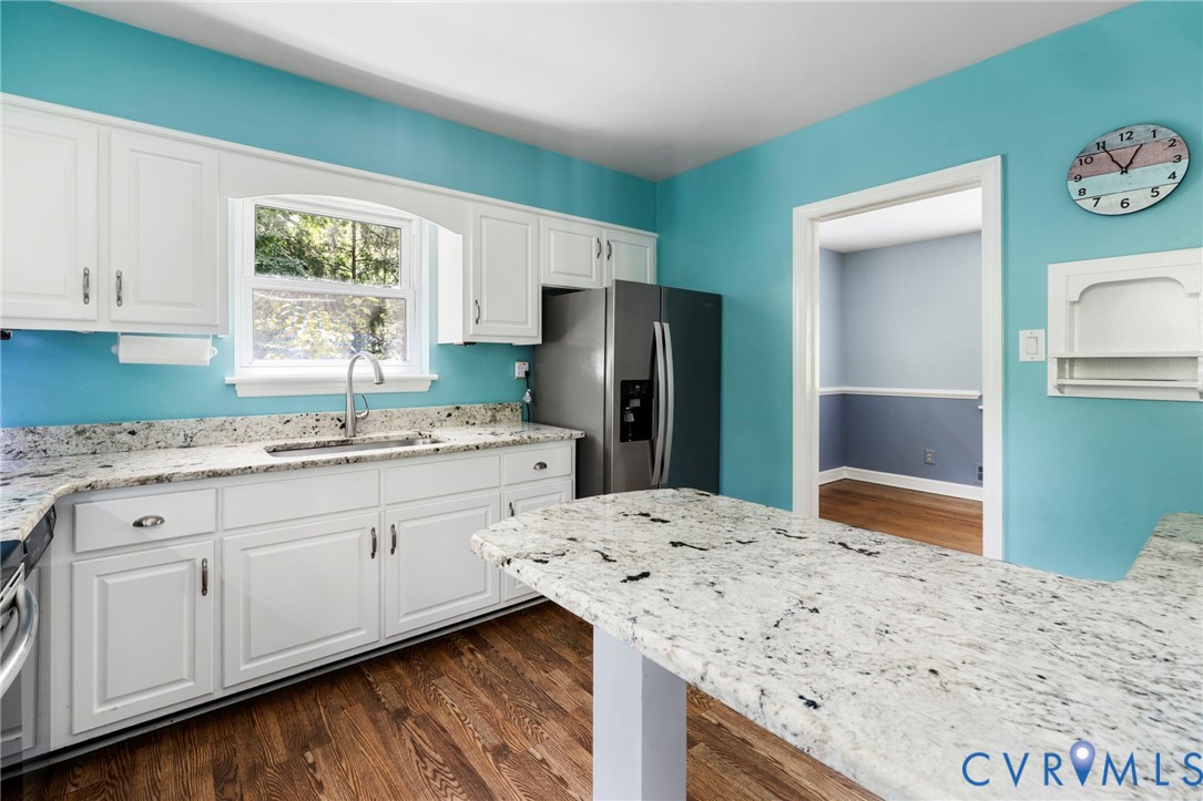 7644 Cherokee Road Richmond, VA 23225 - Photo 13 of 31 Kitchen featuring dark wood-type flooring, stainle