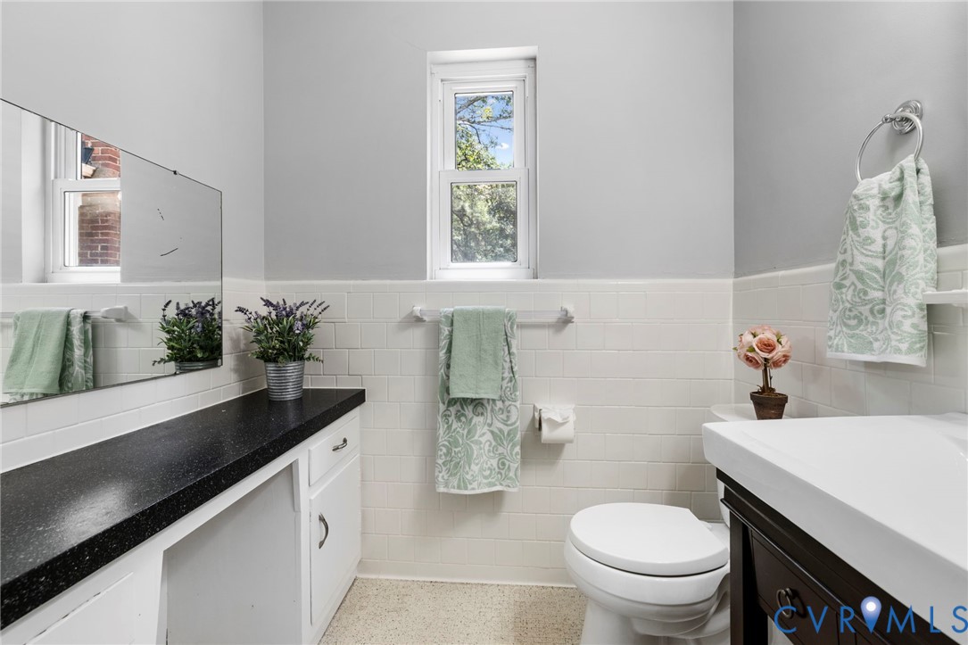 7644 Cherokee Road Richmond, VA 23225 - Photo 20 of 31 Half bath with vanity, speckled floor, and a wains