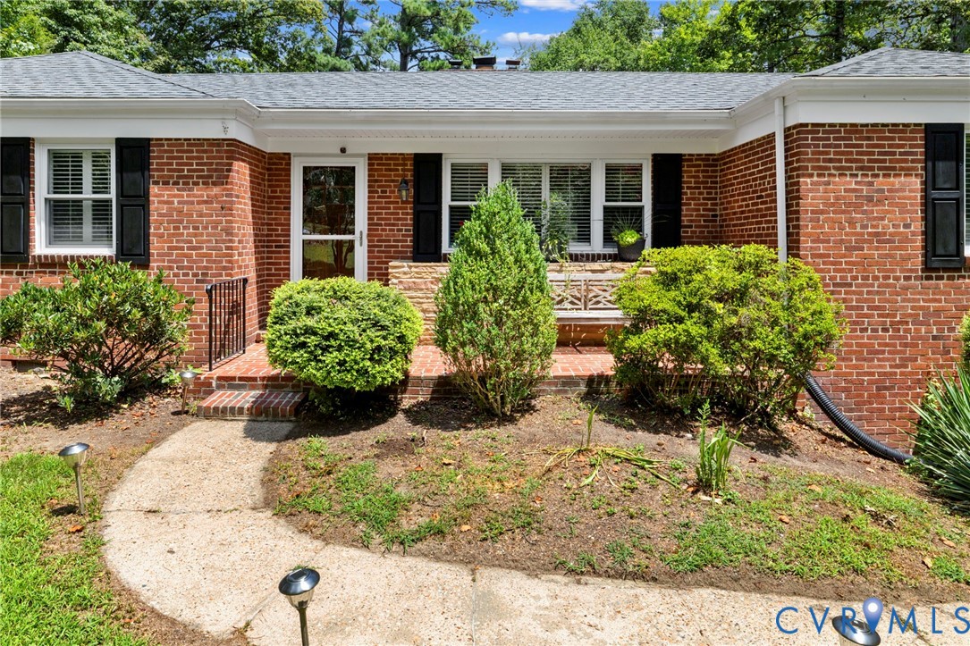 7644 Cherokee Road Richmond, VA 23225 - Photo 4 of 31 Property entrance with brick siding and roof with