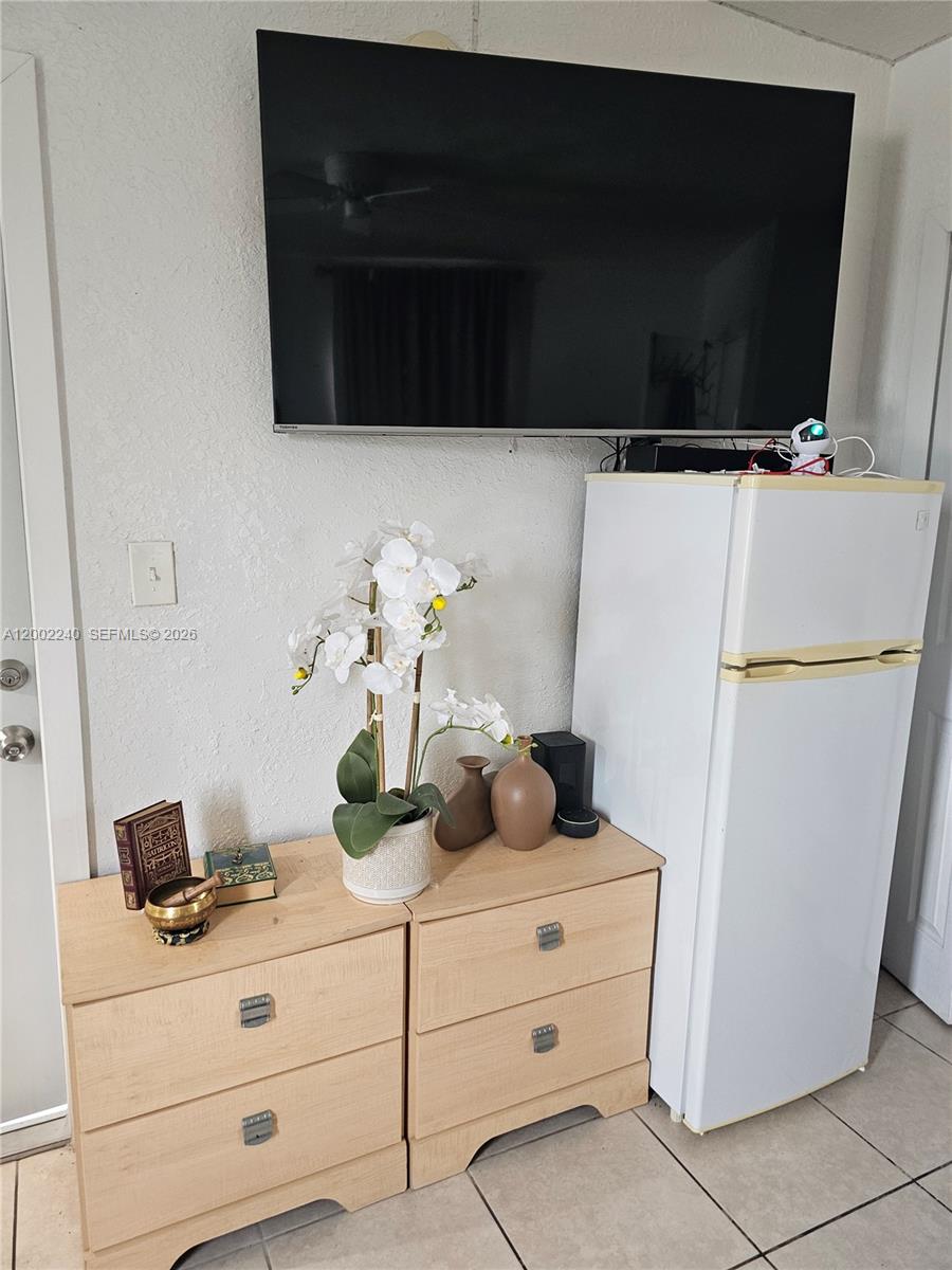 2513 Southwest 10th Street, Unit 5 Miami, FL 33135 - Photo 3 of 5 a bathroom with a sink a refrigerator and cabinets