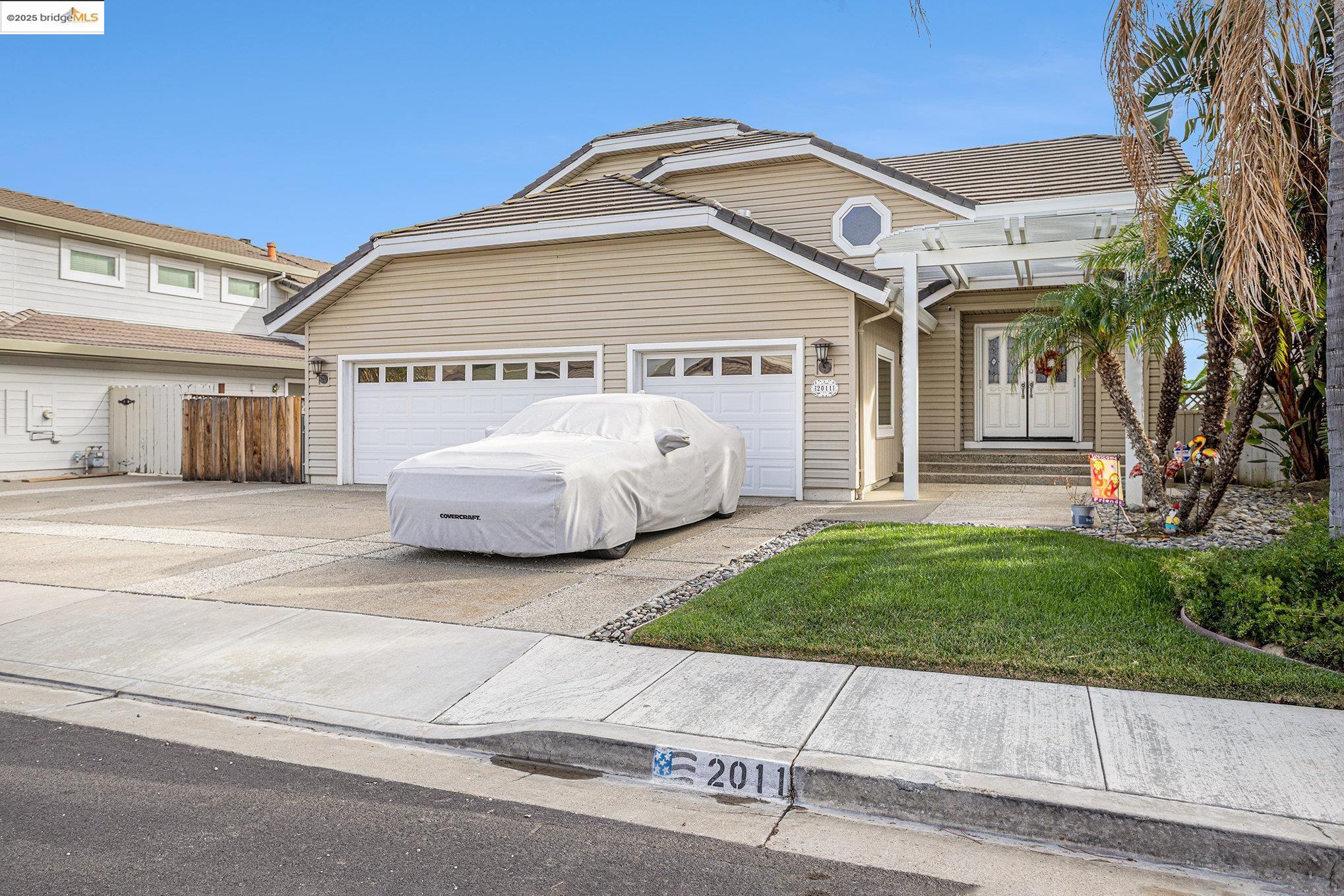 2011 Windward Point Discovery Bay, CA 94505 - Photo 2 of 19 a front view of a house with a garden