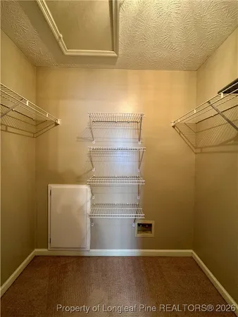a view of storage and utility room with racks on the wall