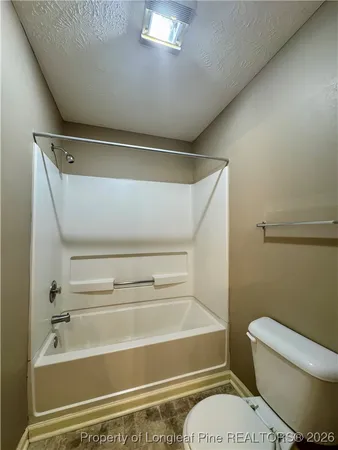 a bathroom with a toilet and a bathtub