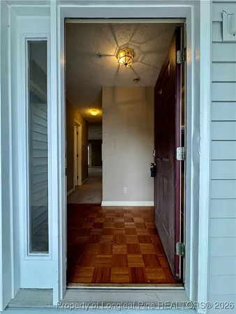 a view of a hallway with a chandelier