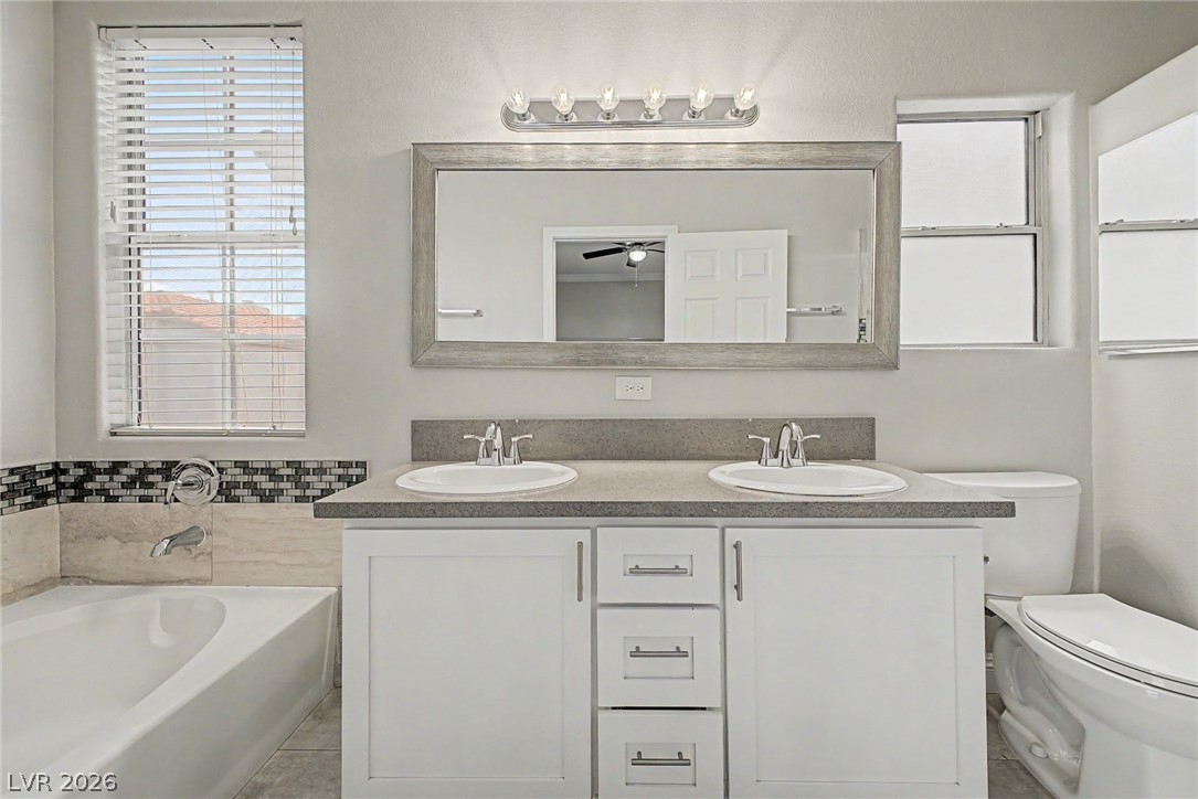 2316 Ramsgate Drive Henderson, NV 89074 - Photo 21 of 28 Double vanity, a spacious tub, and elegant tile accents combine for a well-appointed bathroom.