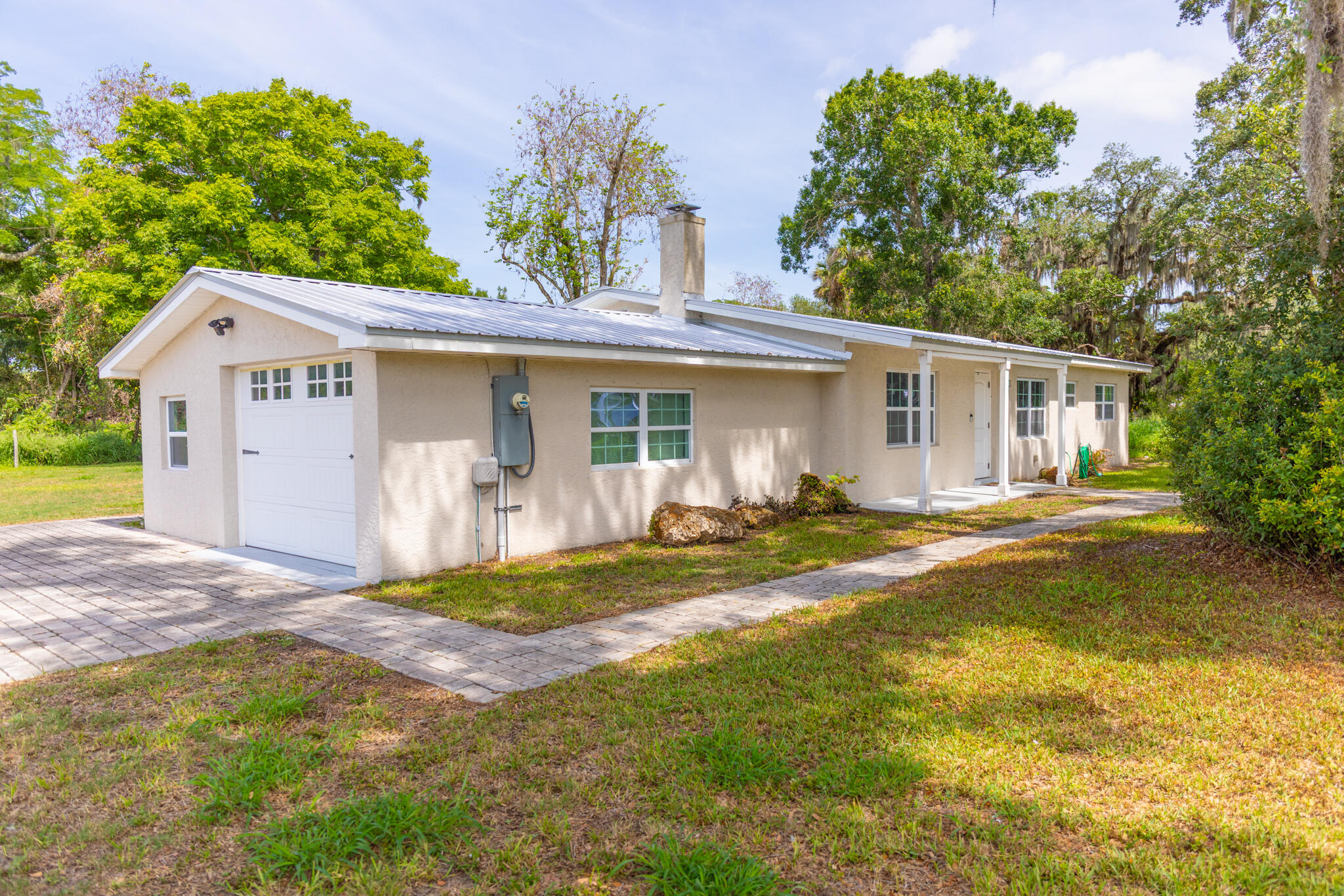 2675 Southwest 24th Avenue Okeechobee, FL 34974 - Photo 15 of 60 a view of a house with a backyard and a tree